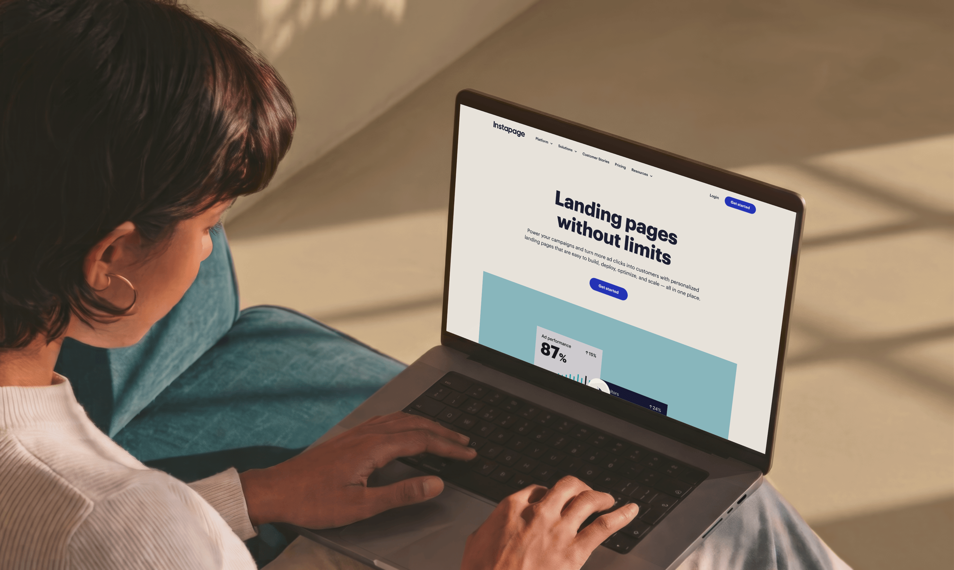 A designer working on the Instapage site on a laptop