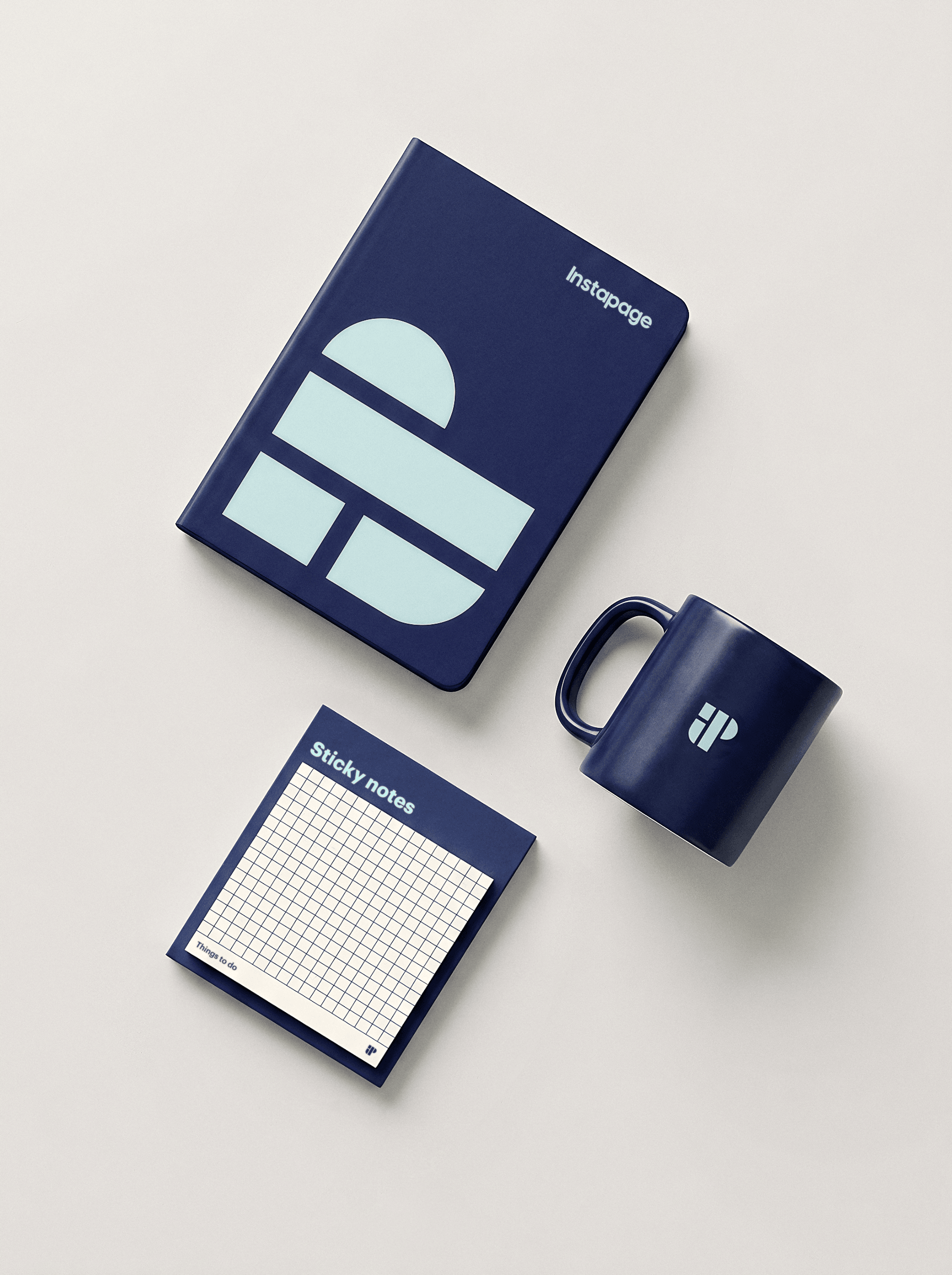 A notebook, mug and sticky notes spread