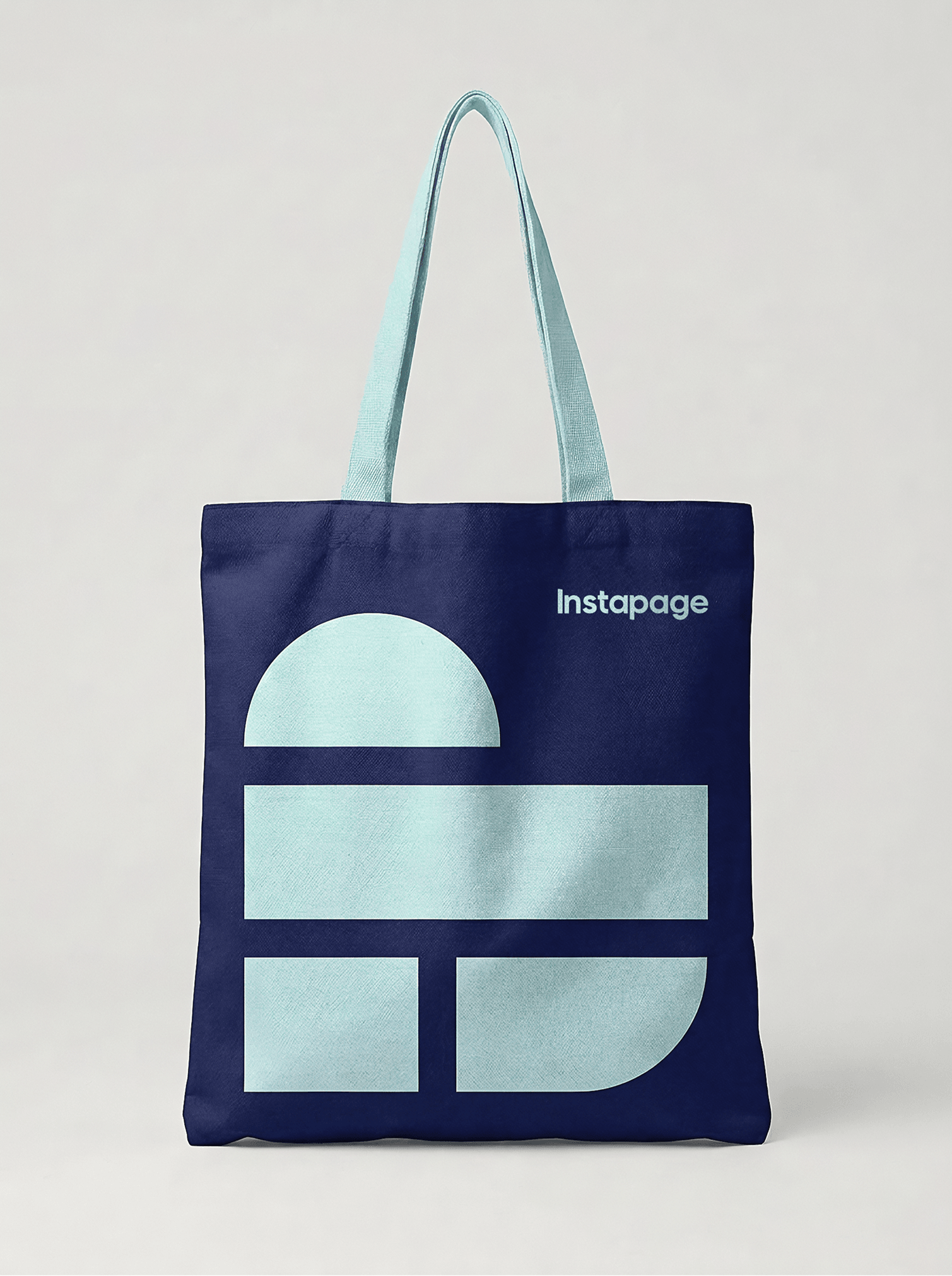 A navy tote bag with the Instapage logo